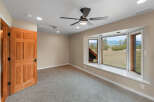 Step into this inviting room, featuring a warm wooden door and plush carpeting for a cozy feel.