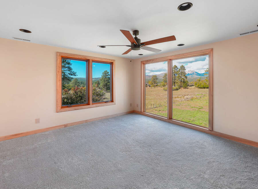 Experience breathtaking mountain views from this spacious room, featuring large windows that flood the space with natural light.