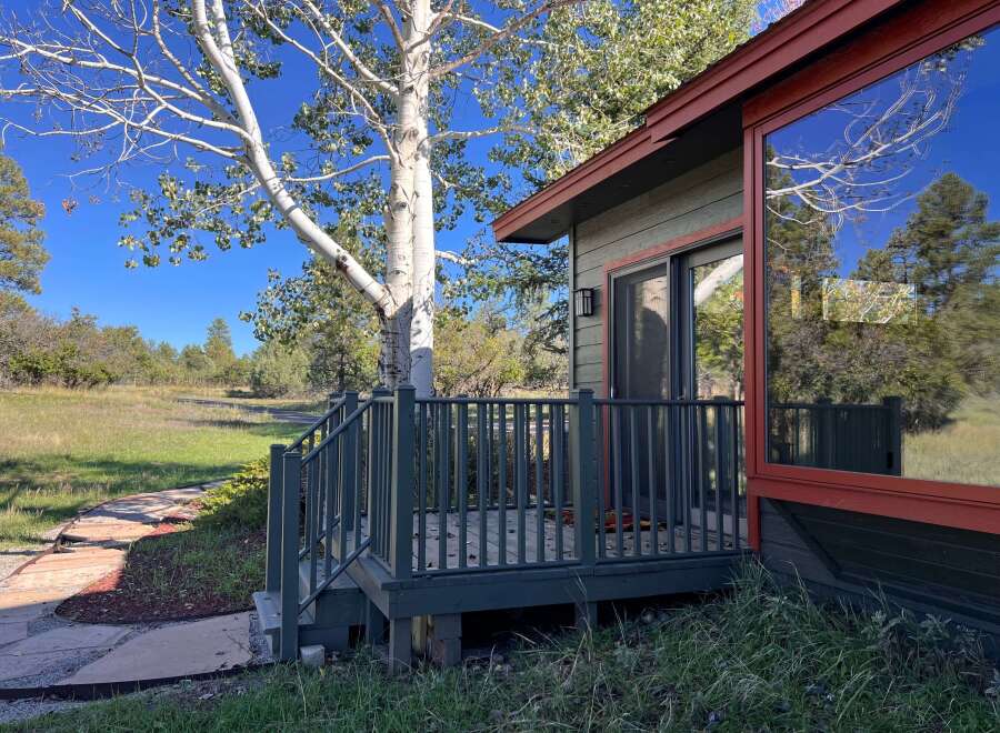 Experience serene living in this charming home, nestled amidst mature trees and lush greenery.
