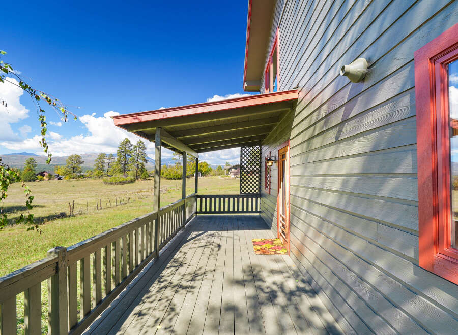 Enjoy the serene mountain views from the expansive covered porch of this charming home.