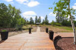 Step onto a spacious wooden deck, perfect for outdoor entertaining and enjoying the serene natural surroundings.