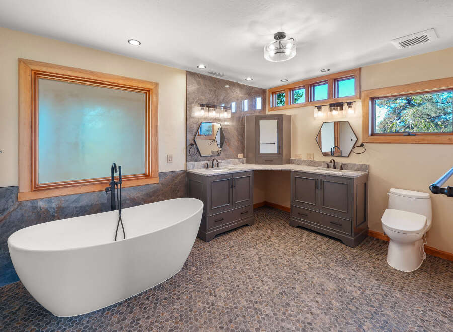 This luxurious bathroom features a stunning freestanding bathtub with a floor-mounted faucet, perfect for a spa-like experience.
