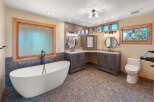 This luxurious bathroom features a stunning freestanding bathtub with a floor-mounted faucet, perfect for a spa-like experience.