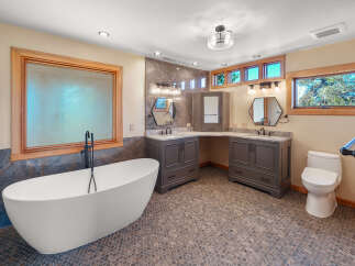 This luxurious bathroom features a stunning freestanding bathtub with a floor-mounted faucet, perfect for a spa-like experience.