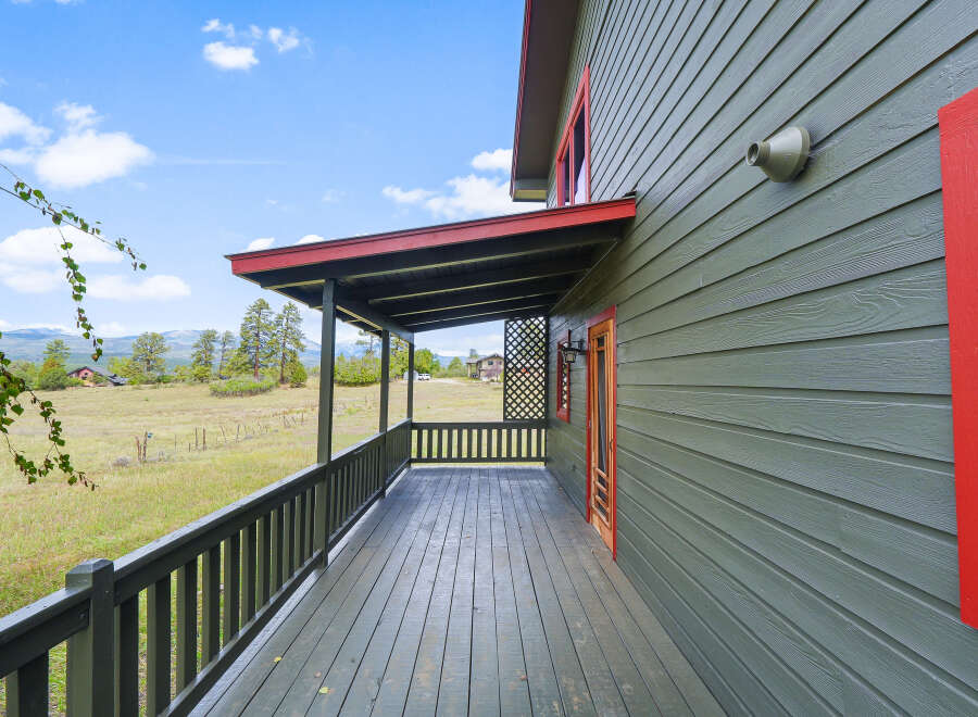 Enjoy the serene mountain views from the expansive covered porch of this charming home.