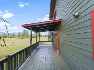 Enjoy the serene mountain views from the expansive covered porch of this charming home.