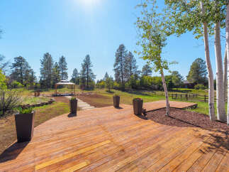 Experience the beauty of nature from this expansive wooden deck, perfect for outdoor entertaining.