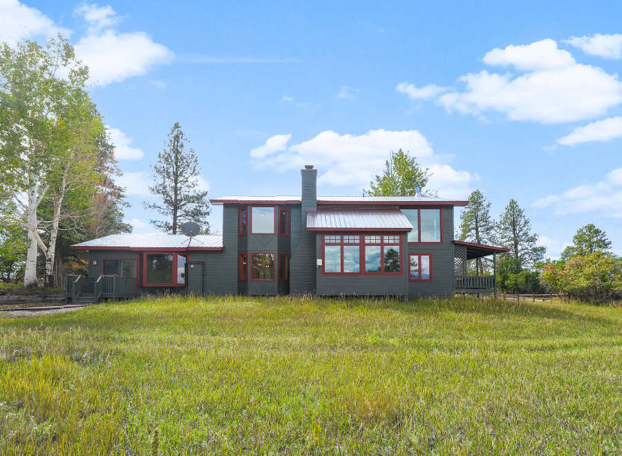 Discover this charming home nestled amidst lush greenery and mature trees, offering a serene retreat.