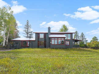 Discover this charming home nestled amidst lush greenery and mature trees, offering a serene retreat.