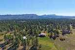 Discover your dream home nestled amidst a serene pine forest, offering breathtaking mountain views.