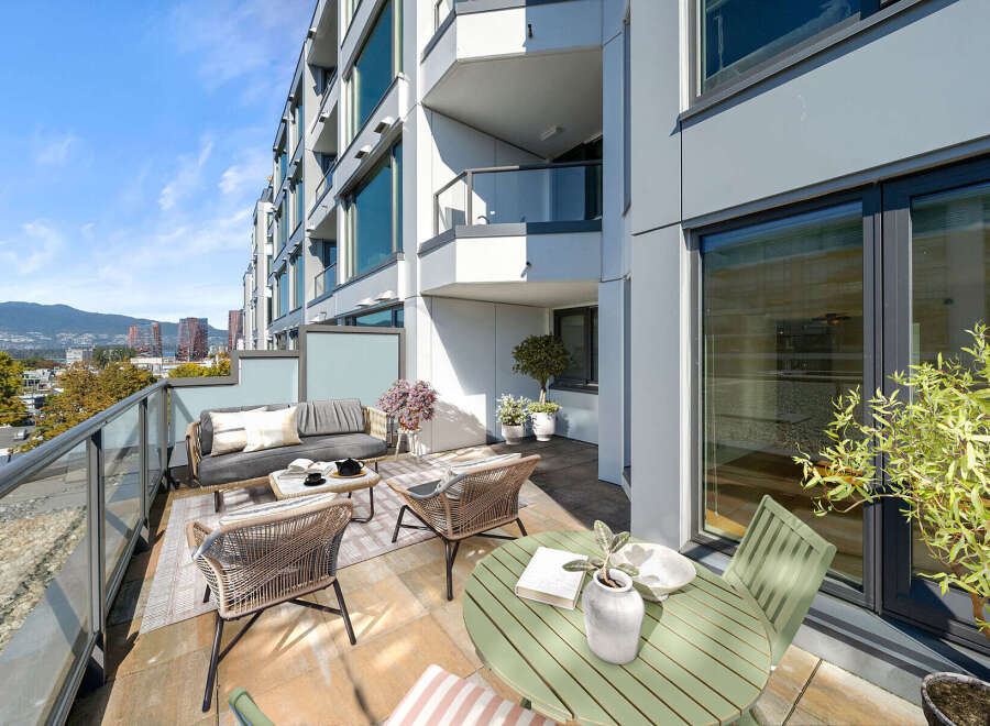Enjoy breathtaking city and mountain views from this expansive balcony, perfect for al fresco dining or relaxing with a book.