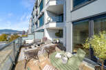 Enjoy breathtaking city and mountain views from this expansive balcony, perfect for al fresco dining or relaxing with a book.