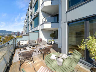 Enjoy breathtaking city and mountain views from this expansive balcony, perfect for al fresco dining or relaxing with a book.