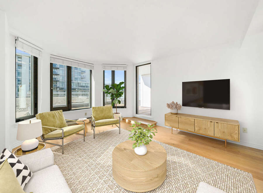 Experience modern living in this bright and airy living room, featuring large windows that flood the space with natural light and offer city views.