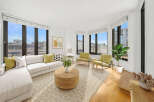 Experience modern living in this bright and airy living room, featuring a spacious sectional sofa and two accent chairs perfect for entertaining.