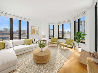 Experience modern living in this bright and airy living room, featuring a spacious sectional sofa and two accent chairs perfect for entertaining.