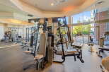 Step into this well-equipped gym, featuring a variety of weight machines and cardio equipment, including treadmills and a rowing machine.