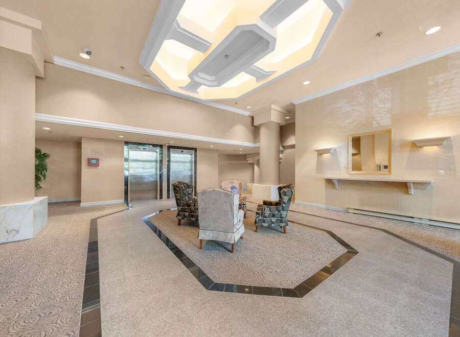 Step into a welcoming lobby featuring elegant seating arrangements and modern elevators, perfect for greeting guests or enjoying a moment of relaxation.