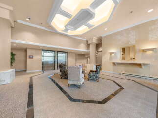 Step into a welcoming lobby featuring elegant seating arrangements and modern elevators, perfect for greeting guests or enjoying a moment of relaxation.
