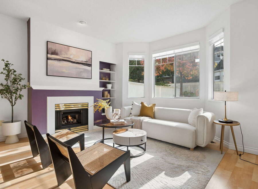 Step into this inviting living room, bathed in natural light from large bay windows.