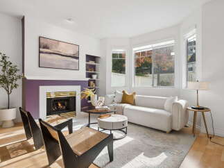 Step into this inviting living room, bathed in natural light from large bay windows.