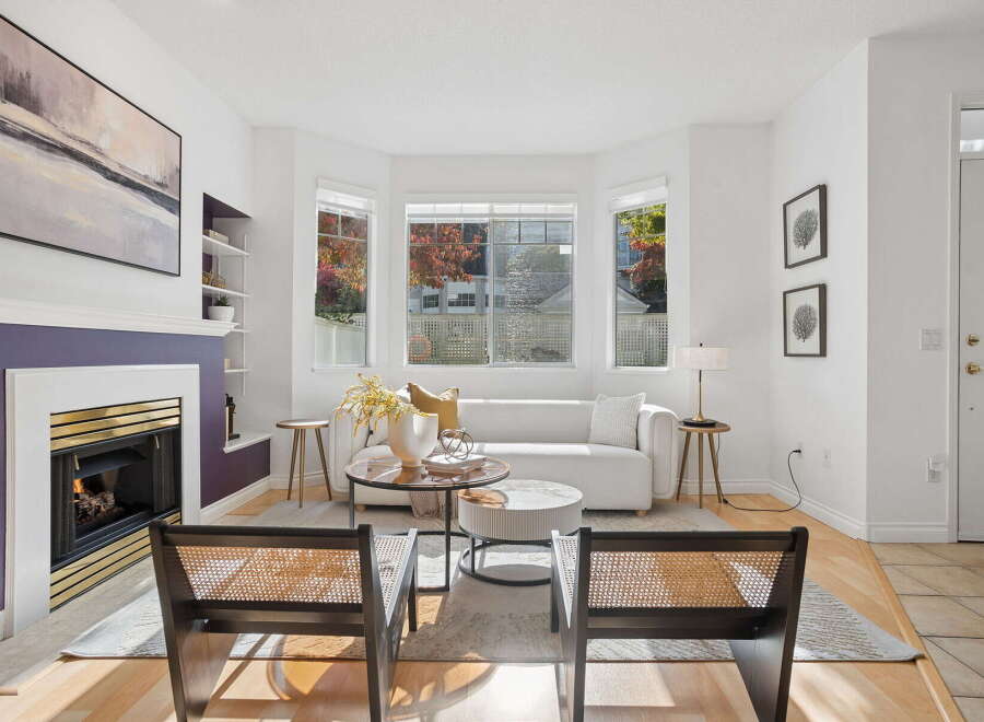Step into this inviting living room, featuring a modern white sofa and a striking purple fireplace as the focal point.