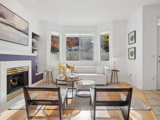 Step into this inviting living room, featuring a modern white sofa and a striking purple fireplace as the focal point.