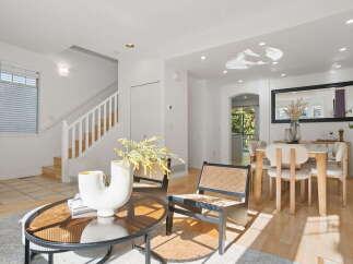 Step into this bright and airy living space, featuring a modern aesthetic with clean lines and a neutral color palette.