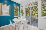 Enjoy bright and airy dining with this charming space, featuring a sleek white tulip table and chairs perfect for intimate meals.
