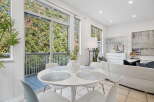 Enjoy abundant natural light and scenic views through the expansive windows and sliding glass doors.