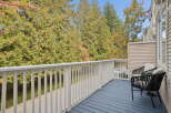 Enjoy your morning coffee on this charming balcony, offering a serene view of lush greenery and mature trees.