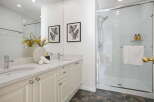 This modern bathroom features a spacious double vanity with ample counter space and elegant cabinetry.