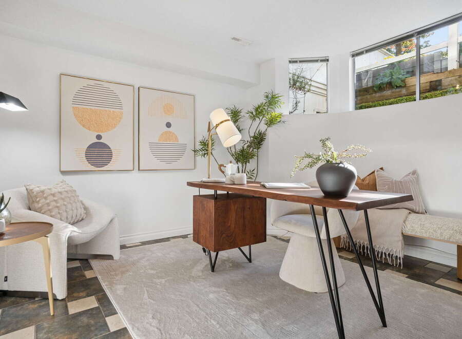 Discover a stylish and functional home office space featuring a modern wooden desk with a unique cabinet and sleek metal legs.