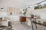 Discover a stylish and functional home office space featuring a modern wooden desk with a unique cabinet and sleek metal legs.