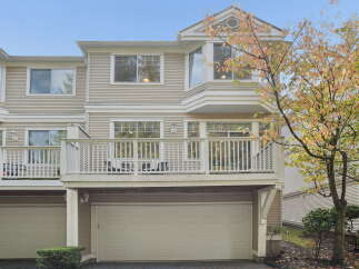 This townhouse offers a spacious deck perfect for outdoor entertaining, overlooking a private backyard.