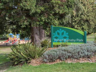 Discover the vibrant community of Robert Burnaby Park, featuring a colorful and engaging playground perfect for family fun.