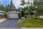 Charming single-story home with a light green exterior and a single-car garage.