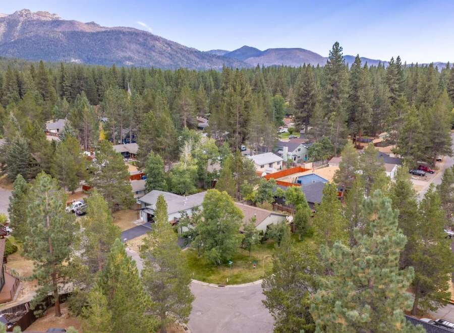 Discover this charming home nestled amidst a serene forest setting, offering a peaceful retreat with stunning mountain views in the distance.