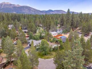 Discover this charming home nestled amidst a serene forest setting, offering a peaceful retreat with stunning mountain views in the distance.