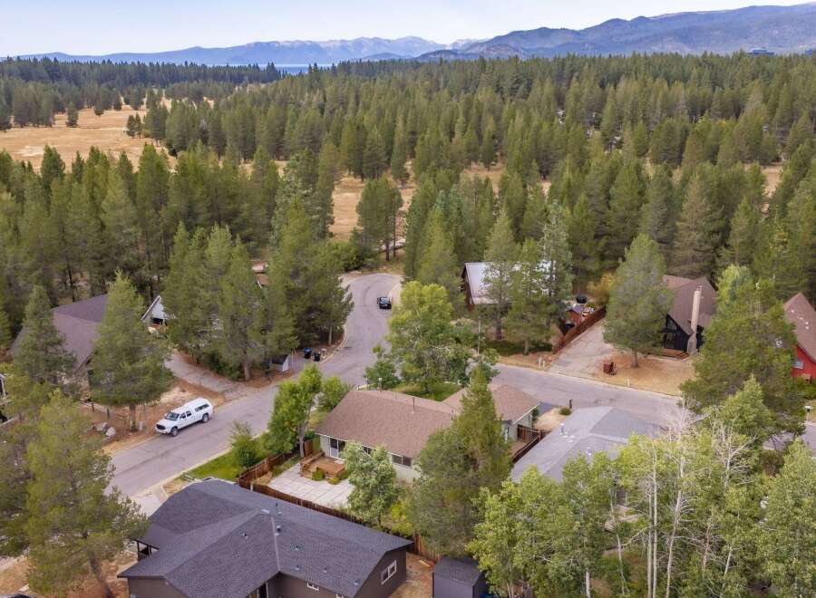 Discover this charming home nestled amidst a serene forest landscape, offering a tranquil retreat.