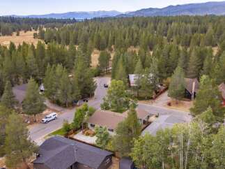 Discover this charming home nestled amidst a serene forest landscape, offering a tranquil retreat.