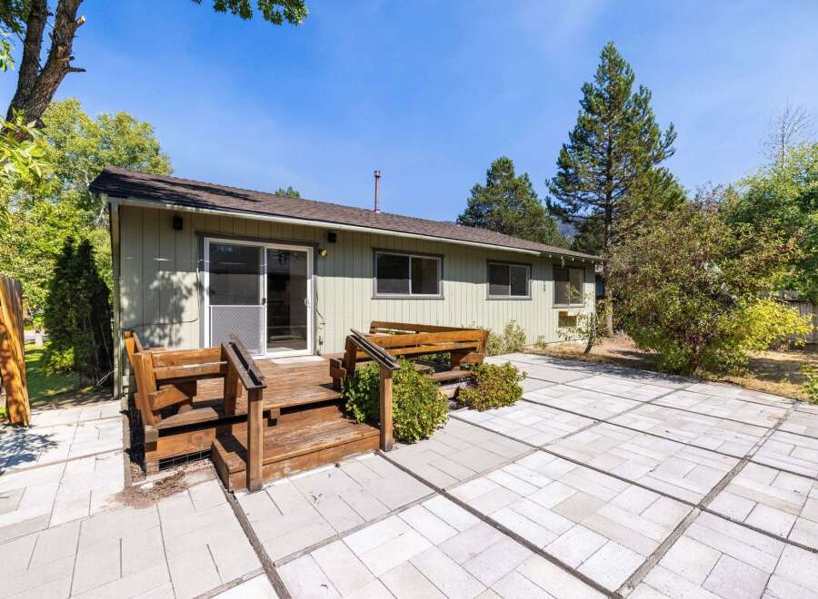Enjoy outdoor living with this spacious patio and wooden deck, perfect for entertaining or relaxing.