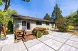 Enjoy outdoor living with this spacious patio and wooden deck, perfect for entertaining or relaxing.