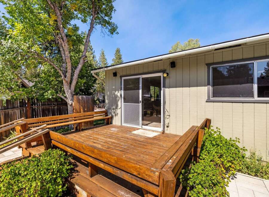Step outside to a charming wooden deck, perfect for enjoying the outdoors.