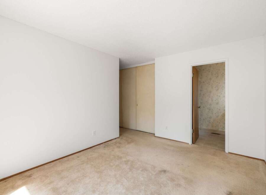 This spacious room features a large closet with sliding doors, perfect for ample storage.