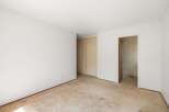 This spacious room features a large closet with sliding doors, perfect for ample storage.