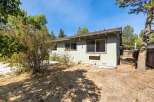 Discover this charming home featuring a light green exterior and a spacious backyard.