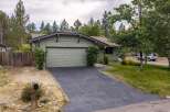 Discover this charming single-family home featuring a light green exterior and a spacious attached garage.