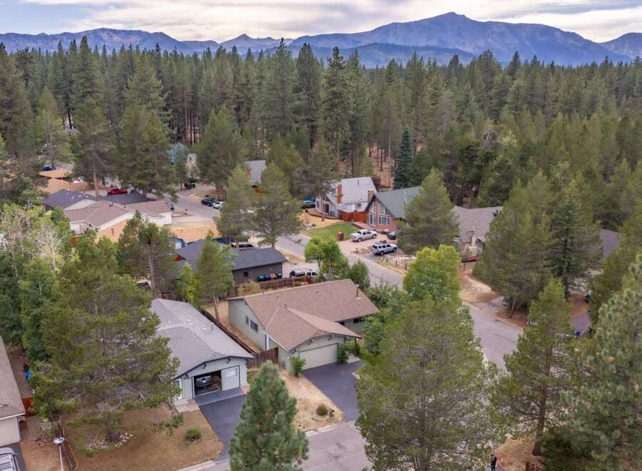 Discover this charming neighborhood nestled amongst towering pine trees, offering a serene and private atmosphere.