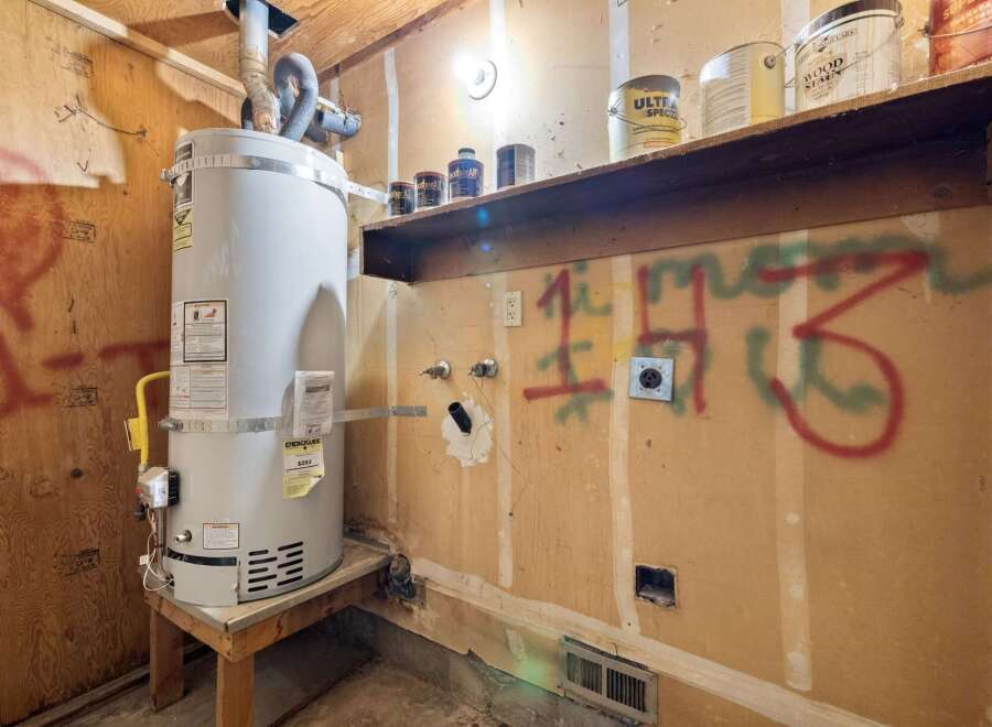 This utility room features a large water heater, perfect for a growing family or busy household.